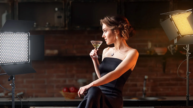 Bi-color LED panels light a woman in a warm, rustic setting.