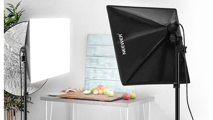 Two softboxes positioned on either side of a product subject, illustrating how directional softbox placement controls spill and shapes light compared to a single bare or umbrella key