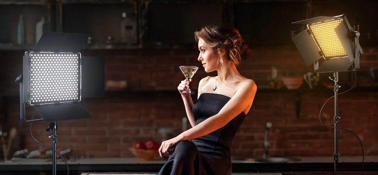Bi-color LED panels light a woman in a warm, rustic setting.